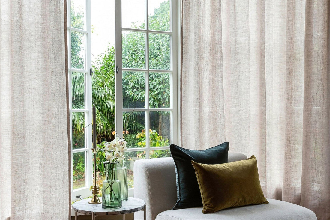 Beautiful Linen natural curtain that drapes in a rustic setting. Velvet Cushions on chair in front .Peaaceful home 