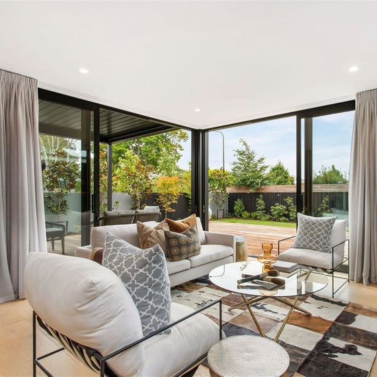 light bright living room space with decortaive cushions and curtains